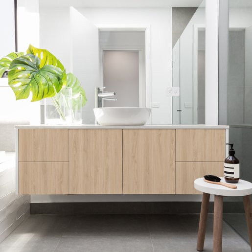 Luxury white family bathroom styled with greenery and a wooden s